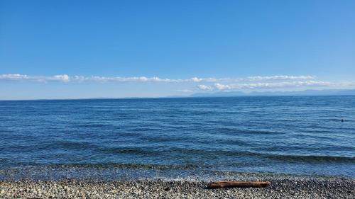 a large body of water with a rocky beach at Haven Touchstone in Roberts Creek