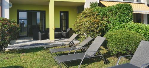 a group of chairs sitting outside of a house at Cielo D'Italia Stella in Cissano