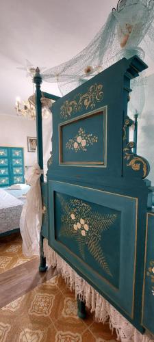 a blue bed with a canopy in a bedroom at Bellavista Versilia in Pietrasanta