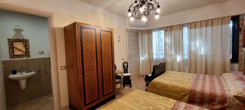 a bedroom with a bed and a sink and a mirror at Bellavista Versilia in Pietrasanta