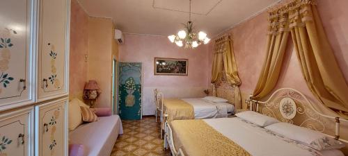 a bedroom with two beds and a chandelier at Bellavista Versilia in Pietrasanta