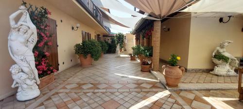a courtyard with statues and plants in a building at Bellavista Versilia in Pietrasanta