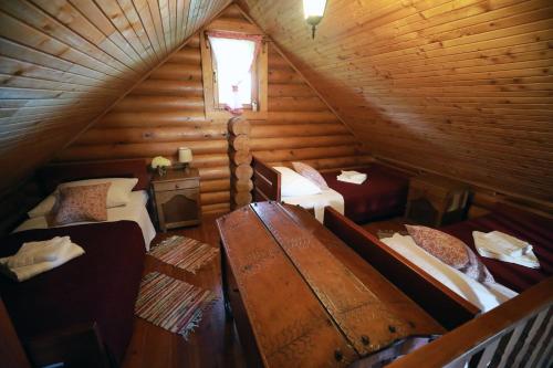 an attic room with two beds and a window at Garić Bajka in Križevci