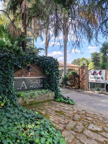 a sign for a coffee house with ivy at LA Guesthouse in Piet Retief