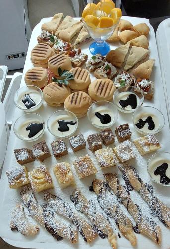 a table topped with different types of pastries and desserts at Bellavista Versilia in Pietrasanta