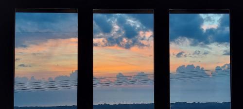 a view of a sunset through a window at Bellavista Versilia in Pietrasanta