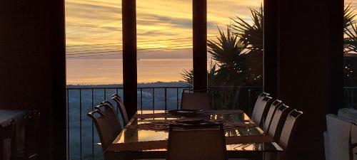 a table on a balcony with a view of the ocean at Bellavista Versilia in Pietrasanta