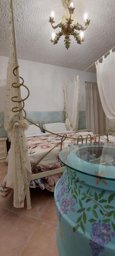a bedroom with a bed and a chandelier at Bellavista Versilia in Pietrasanta