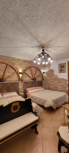 a bedroom with two beds and a chandelier at Bellavista Versilia in Pietrasanta