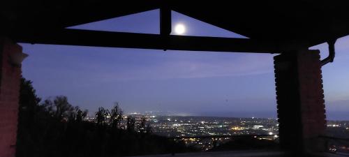 a window with a view of a city at night at Bellavista Versilia in Pietrasanta