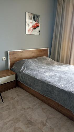 a bedroom with a bed and a nightstand next to a bed sidx sidx sidx at ПЕРВАЯ ЛИНИЯ Apartment Zhemchuzhina Ureki-6 STUDI0 in Ureki