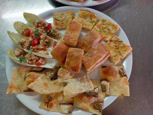 a white plate of food with different types of food at Bellavista Versilia in Pietrasanta