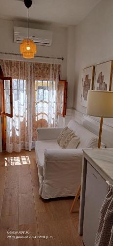 a bedroom with two beds and a chandelier at La Casita de Las Eras in Níjar