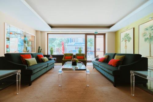 a living room with two couches and a table at Hotel Miramare in Civitanova Marche
