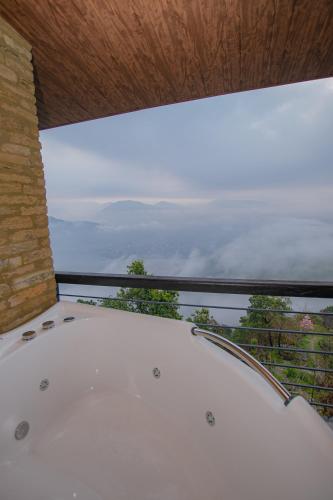 a room with a window with a view of the mountains at Raniban Retreat in Pokhara