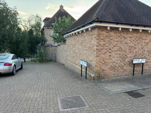 a brick building with a car parked next to it at Riverview Colchester in Colchester