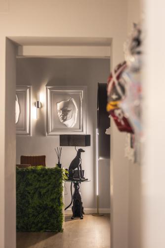 a living room with a table and a lamp at ReMia Suites & Leisure in Alassio