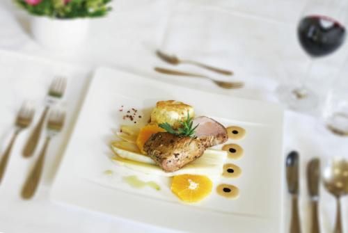 a white plate with food on a table at Alpenhotel Tirol in Galtür