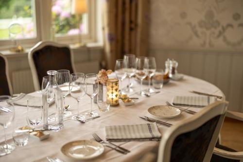 a table with wine glasses and silverware on it at Hestraviken Hotell & Spa in Hestra
