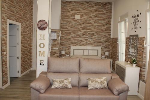 a living room with a couch and a brick wall at Estupendo Loft Plaza de Toros in Alicante