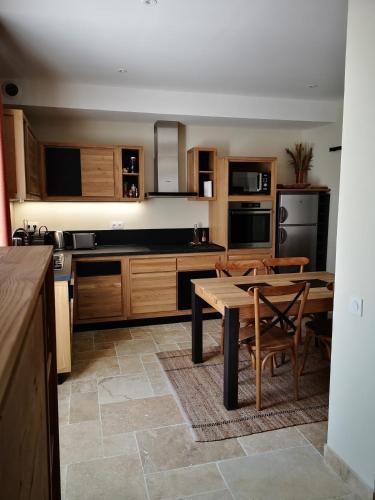 une cuisine avec une table en bois et une salle à manger dans l'établissement Appartement dans le centre ville Avignon, à Avignon