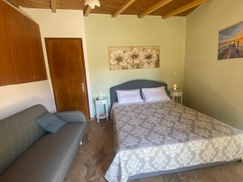 a bedroom with a bed and a couch at Stefanos house in Parga