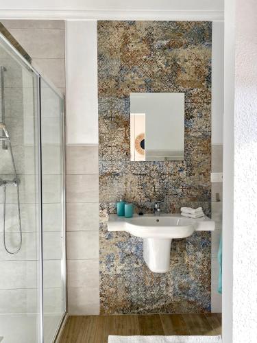 a bathroom with a sink and a mirror at Casa de Los Lirios in Muro de Alcoy