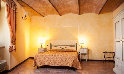 a bedroom with a bed and two night stands at Villa Borri in Casciana Terme