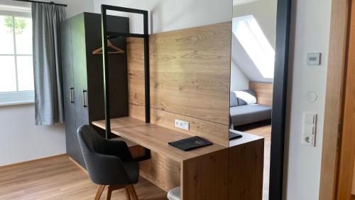 a room with a vanity with a mirror and a chair at Narnhoferwirt in Sankt Jakob im Walde