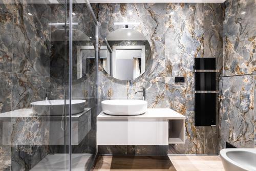 a bathroom with two sinks and a mirror at ReMia Suites & Leisure in Alassio
