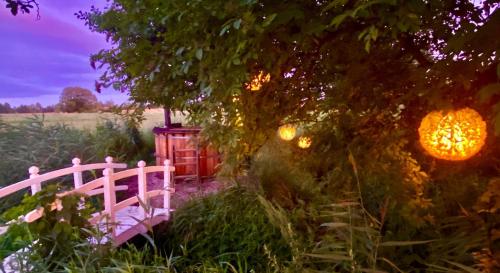 a pink bridge in the middle of a garden at dla mnie się podoba in Krzywiec