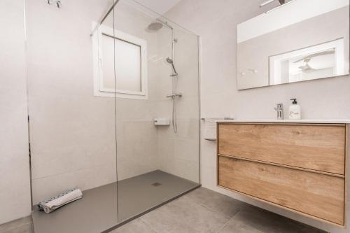 a bathroom with a glass shower and a sink at Aparto Almi in Moraira