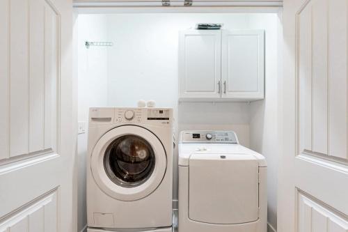 a white laundry room with a washer and dryer at Sawgrass at White Oak --- 21428 Catalina Cir, Unit #C-75 in Dewey Beach