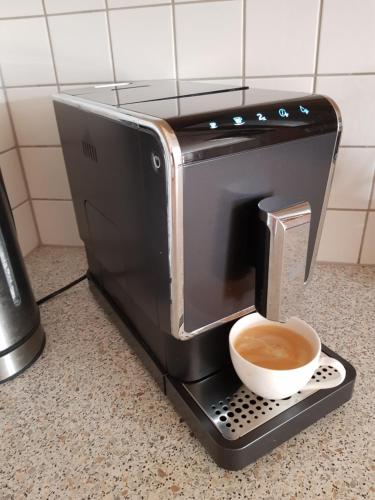 a toaster sitting on a counter with a cup of coffee at Antares am See in Maurach