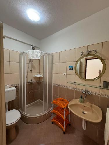 a bathroom with a shower and a sink and a toilet at Apartment Ivanka in Pag