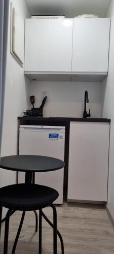 a kitchen with a table and two chairs and a sink at Garden House in Pruszcz Gdański