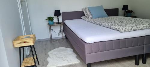 a bedroom with a bed and a nightstand with a table at Garden House in Pruszcz Gdański