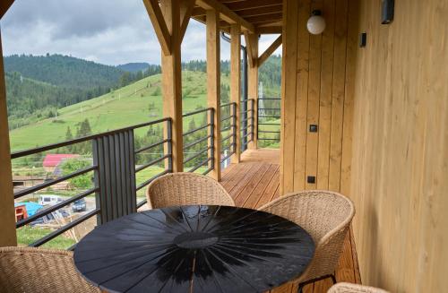 a black umbrella sitting on a table on a balcony at Шале Green Land in Bukovel