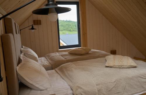 two beds in a room with a window at Шале Green Land in Bukovel