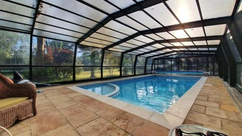 an indoor swimming pool with a retractable ceiling at The Stoat House in St. Leonards