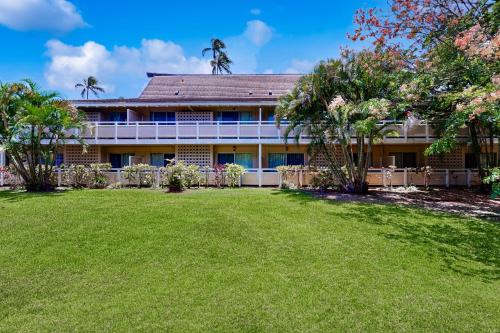 an exterior view of a house with a yard at Plantation Hale in Kapaa