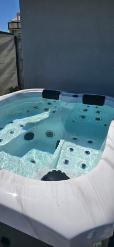 a jacuzzi tub with water and rocks in it at Panorama Apartments in Povljana