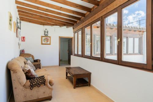 a living room with a couch and a table at Hotel La Quinta de Santillán in Chinchón