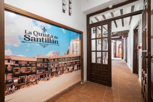 a door to a building with a sign that reads la quinta santa ana at Hotel La Quinta de Santillán in Chinchón