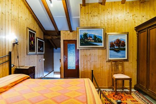 a bedroom with a bed and paintings on the wall at Cozy Castello in Manerba del Garda