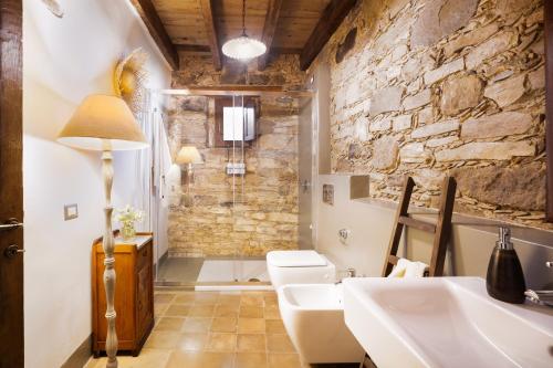 a bathroom with two sinks and a shower at Bissantica, heritage and charm in rural Sardinia in Lunamatrona