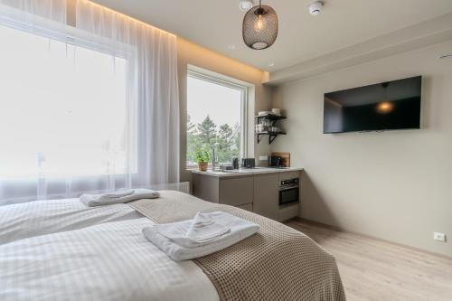 a bedroom with a bed and a sink and a window at Frost Apartments by Heimaleiga in Reykjavík