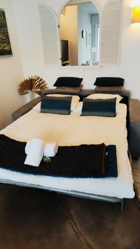 un grand lit avec deux oreillers dessus dans l'établissement Appartement Cannes Centre Proche de la Croisette!, à Cannes