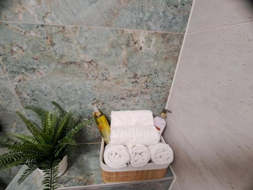 a pile of towels in a basket in a bathroom at Apartment CityAna - private garage, 0-24 Self Check In in Zagreb