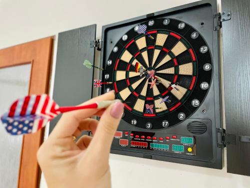 a person holding a dartboard with an american flag at Central Apartment Stylovy Mezonet in Košice